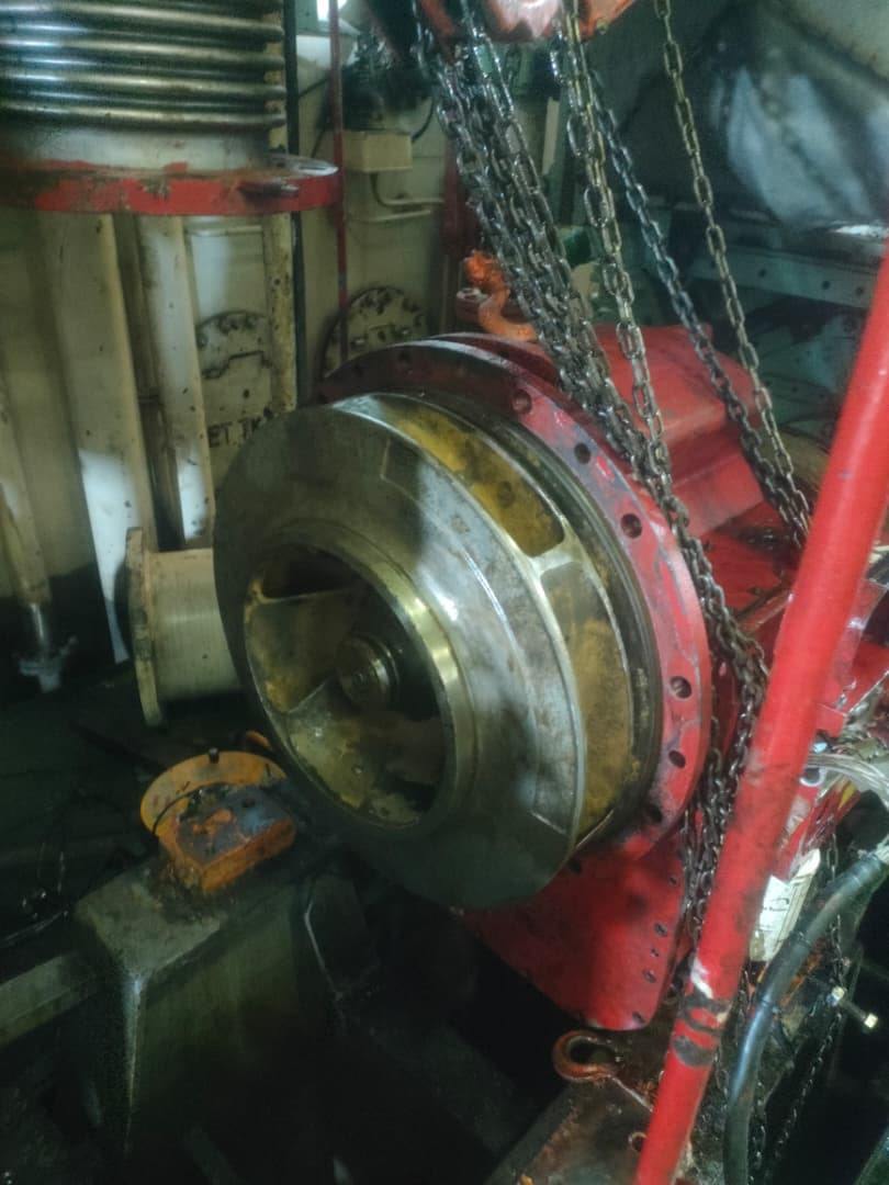 Crew rigging a hydraulic cylinder with deck cranes offshore